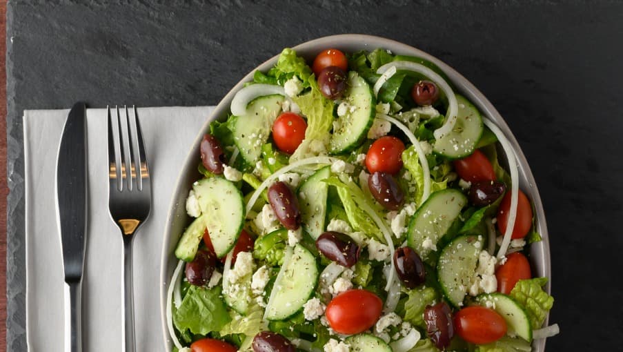 Fresh greek salad with cucumbers, olives, cherry tomatoes and feta cheese